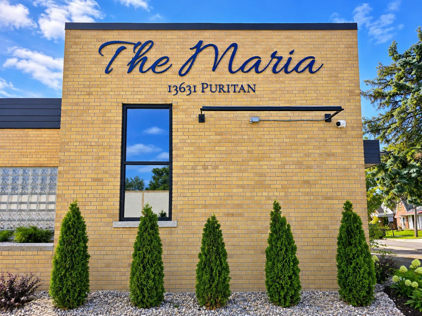 The wall sign on the north side of The Maria, seen at an angle from the corner of the building.